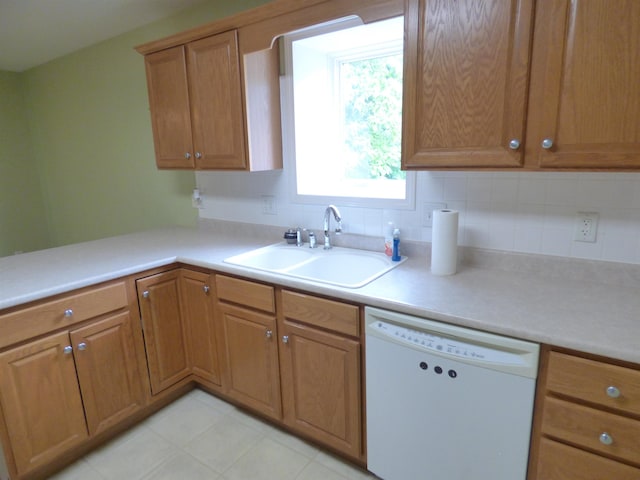 8202 Red Shank Ln, Fort Wayne, IN 46825 - kitchen featuring white dishwasher, a sink, light countertops, light tile patterned floors, and brown cabinets