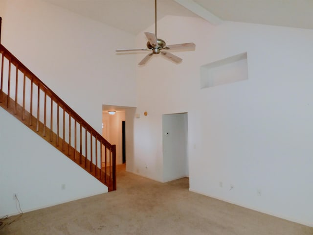 8202 Red Shank Ln, Fort Wayne, IN 46825 - unfurnished living room with carpet floors, high vaulted ceiling, a ceiling fan, and stairs
