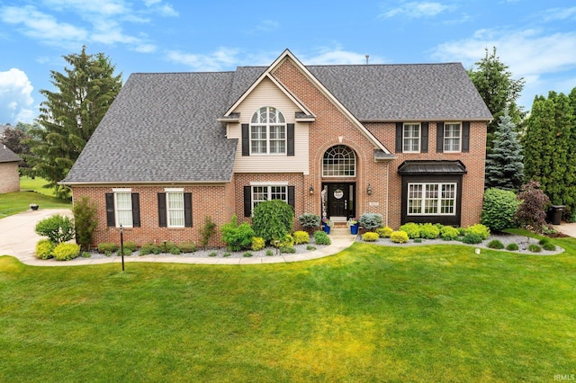 14609 Carrigan Ct, Granger, IN 46530 - traditional home with brick siding, a front yard, and a shingled roof