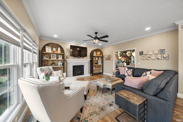14609 Carrigan Ct, Granger, IN 46530 - living room with wood finished floors, a ceiling fan, a fireplace, recessed lighting, and baseboards