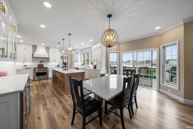 14609 Carrigan Ct, Granger, IN 46530 - dining area featuring a chandelier, wood finished floors, crown molding, recessed lighting, and baseboards