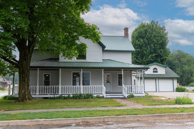 400 E Center St, North Liberty, IN 46554 - farmhouse inspired home featuring covered porch, metal roof, a garage, and a chimney