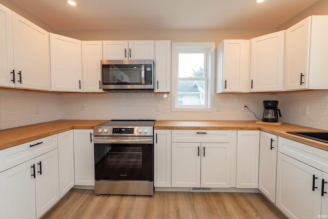 400 E Center St, North Liberty, IN 46554 - kitchen featuring stainless steel appliances, butcher block countertops, light wood finished floors, recessed lighting, and decorative backsplash
