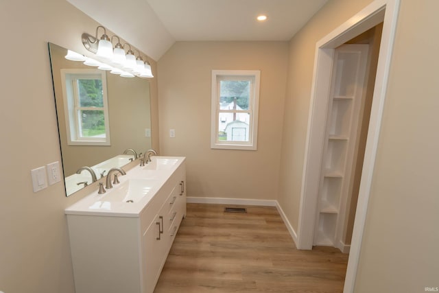 400 E Center St, North Liberty, IN 46554 - full bathroom with double vanity, healthy amount of natural light, wood finished floors, baseboards, and recessed lighting