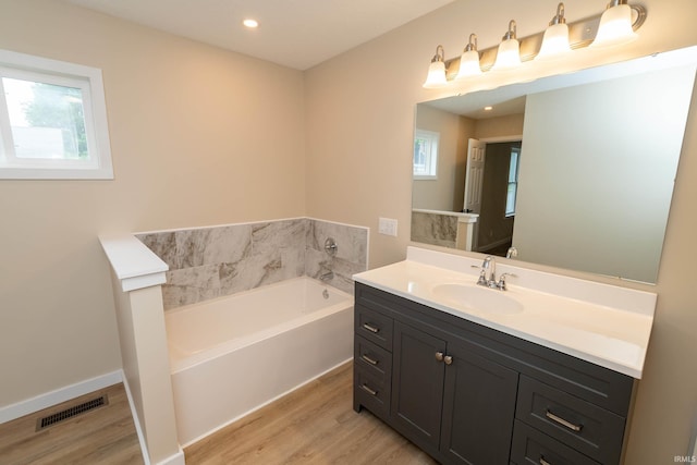 400 E Center St, North Liberty, IN 46554 - bathroom with wood finished floors, a garden tub, vanity, and recessed lighting