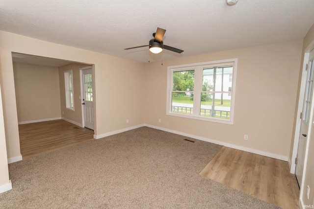 400 E Center St, North Liberty, IN 46554 - carpeted spare room with a ceiling fan, baseboards, and wood finished floors