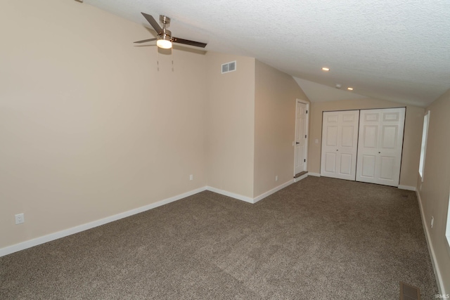 400 E Center St, North Liberty, IN 46554 - unfurnished bedroom featuring lofted ceiling, dark carpet, baseboards, a textured ceiling, and recessed lighting
