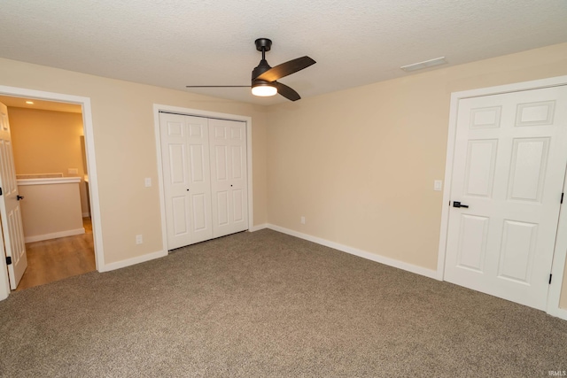 400 E Center St, North Liberty, IN 46554 - unfurnished bedroom featuring carpet, a closet, a textured ceiling, baseboards, and a ceiling fan