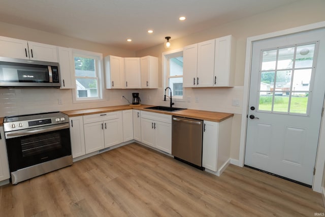 400 E Center St, North Liberty, IN 46554 - kitchen with appliances with stainless steel finishes, wood counters, a sink, recessed lighting, and light wood-style flooring