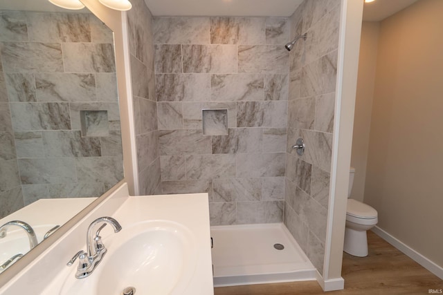400 E Center St, North Liberty, IN 46554 - full bathroom featuring toilet, a tile shower, vanity, and wood finished floors