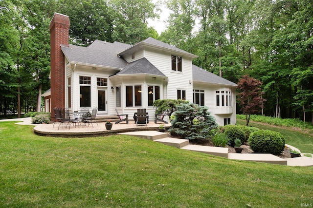 2307 Stacey Hollow Pl, Lafayette, IN 47905 - back of house featuring a chimney, a lawn, a patio, and roof with shingles