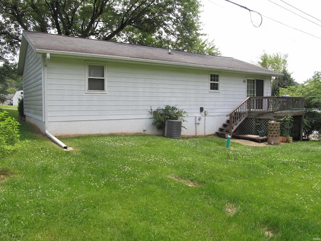 1053 E Smith Cir, Paoli, IN 47454 - rear view of property featuring a deck, a yard, and central AC unit