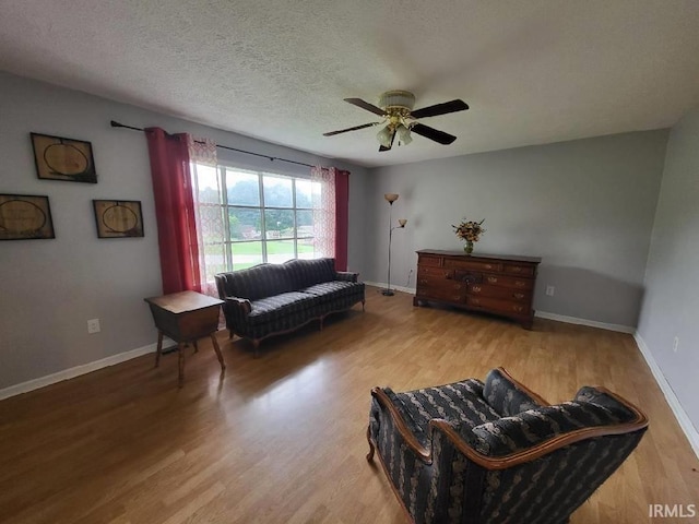 1053 E Smith Cir, Paoli, IN 47454 - sitting room featuring a ceiling fan, wood finished floors, baseboards, and a textured ceiling
