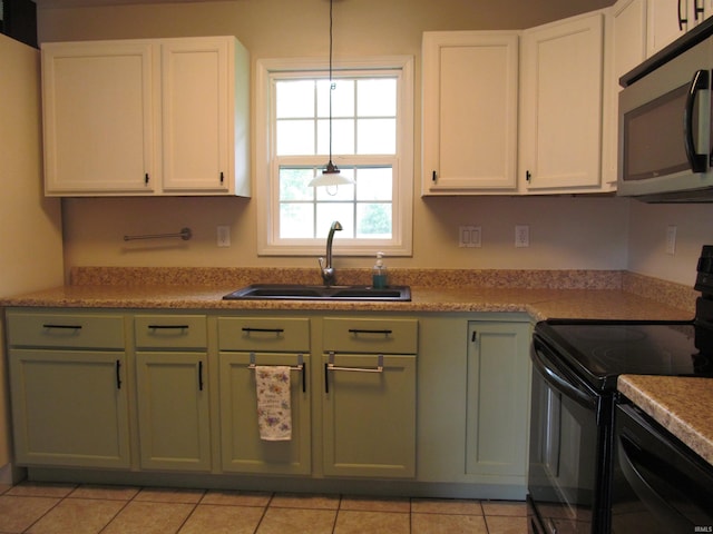 1053 E Smith Cir, Paoli, IN 47454 - kitchen featuring black appliances, green cabinetry, a sink, and white cabinets