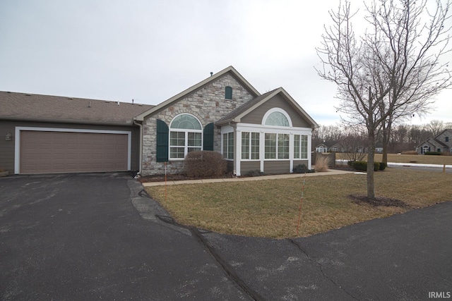4654 Ironstone Ln, West Lafayette, IN 47906 - single story home featuring stone siding, asphalt driveway, an attached garage, and a front yard