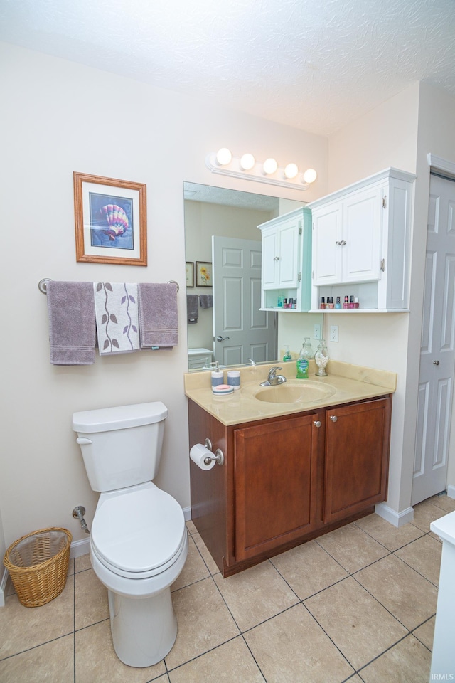 4654 Ironstone Ln, West Lafayette, IN 47906 - bathroom with vanity, toilet, tile patterned flooring, baseboards, and a textured ceiling