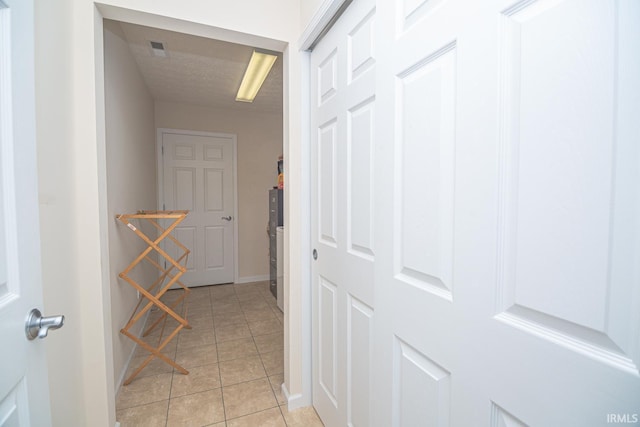 4654 Ironstone Ln, West Lafayette, IN 47906 - hallway featuring light tile patterned floors, baseboards, and a textured ceiling