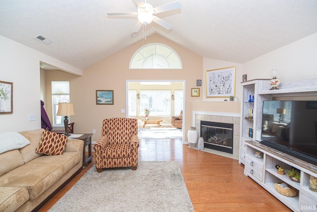 4654 Ironstone Ln, West Lafayette, IN 47906 - living area with wood finished floors, lofted ceiling, a ceiling fan, and a tile fireplace