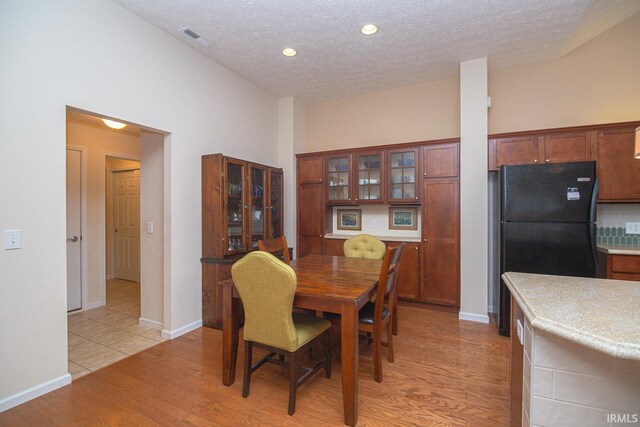 4654 Ironstone Ln, West Lafayette, IN 47906 - dining area featuring a textured ceiling, light wood finished floors, baseboards, and recessed lighting