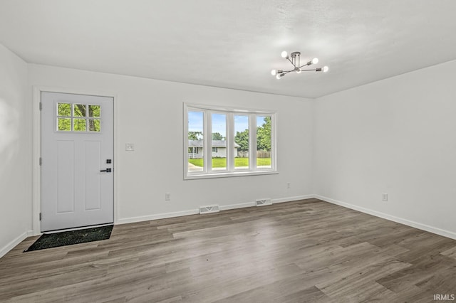 57372 Arabian Dr, Goshen, IN 46528 - foyer entrance with a chandelier, baseboards, and wood finished floors