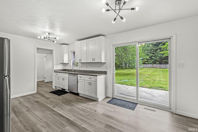 57372 Arabian Dr, Goshen, IN 46528 - kitchen with a chandelier, a sink, stainless steel appliances, and baseboards