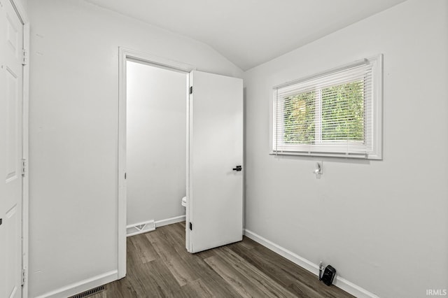 57372 Arabian Dr, Goshen, IN 46528 - unfurnished bedroom featuring wood finished floors, vaulted ceiling, and baseboards