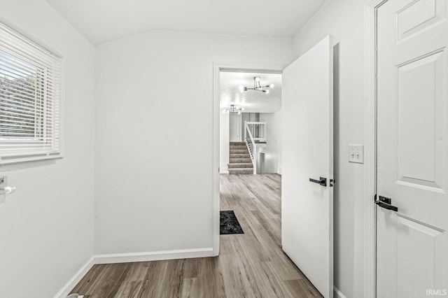 57372 Arabian Dr, Goshen, IN 46528 - hall with wood finished floors, baseboards, stairway, and a chandelier