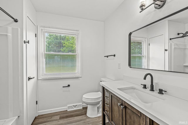 57372 Arabian Dr, Goshen, IN 46528 - full bath with vanity, a shower, wood finished floors, toilet, and baseboards