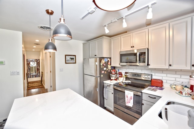 8020 N W Shafer Dr, Monticello, IN 47960 - kitchen featuring appliances with stainless steel finishes, backsplash, pendant lighting, and rail lighting