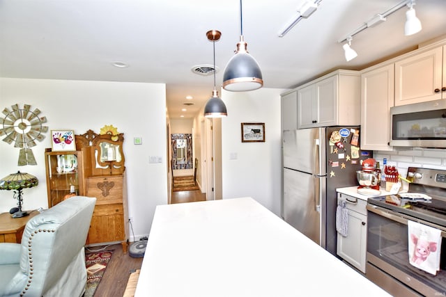 8020 N W Shafer Dr, Monticello, IN 47960 - kitchen featuring stainless steel appliances, light countertops, wood finished floors, pendant lighting, and decorative backsplash