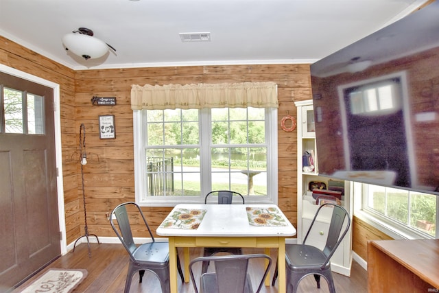 8020 N W Shafer Dr, Monticello, IN 47960 - dining area with plenty of natural light, wood walls, dark wood-type flooring, and baseboards