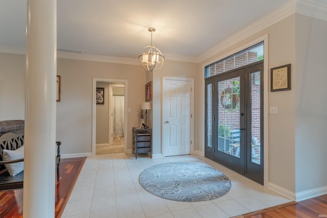 2534 Wheaton Dr, Evansville, IN 47725 - foyer entrance with ornamental molding, french doors, baseboards, a chandelier, and light tile patterned floors