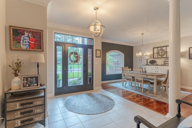 2534 Wheaton Dr, Evansville, IN 47725 - tiled foyer entrance with a chandelier, ornamental molding, baseboards, and ornate columns
