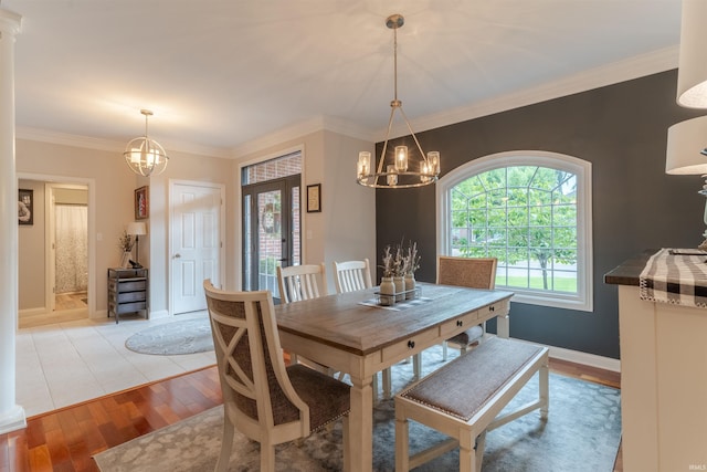 2534 Wheaton Dr, Evansville, IN 47725 - dining area featuring a chandelier, light wood-style flooring, crown molding, and baseboards