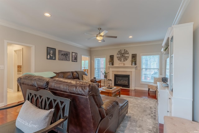 2534 Wheaton Dr, Evansville, IN 47725 - living room featuring wood finished floors, ceiling fan, healthy amount of natural light, a tiled fireplace, and crown molding