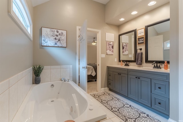 2534 Wheaton Dr, Evansville, IN 47725 - bathroom featuring double vanity, a jetted tub, ensuite bathroom, tile patterned floors, and a ceiling fan