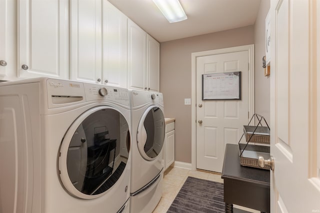 2534 Wheaton Dr, Evansville, IN 47725 - washroom with cabinet space, washer and clothes dryer, light tile patterned floors, and baseboards