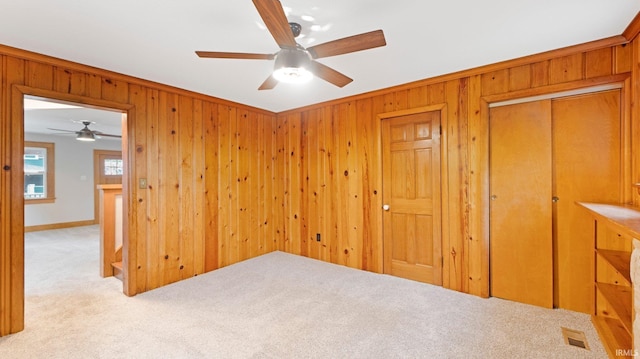 4112 Arlington Ave, Fort Wayne, IN 46807 - unfurnished bedroom with carpet floors, wooden walls, and a ceiling fan