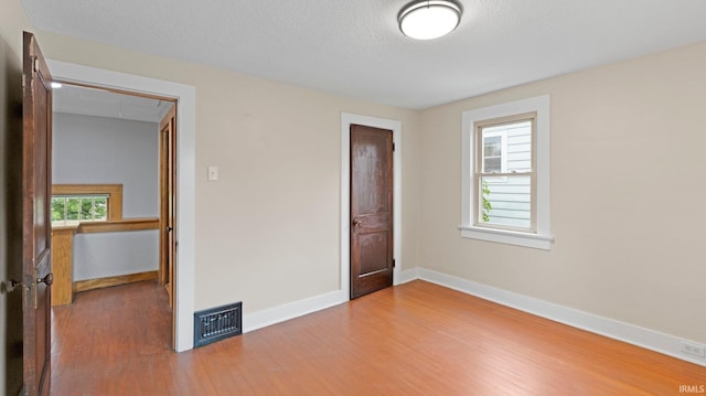 4112 Arlington Ave, Fort Wayne, IN 46807 - unfurnished bedroom featuring wood finished floors, baseboards, and attic access