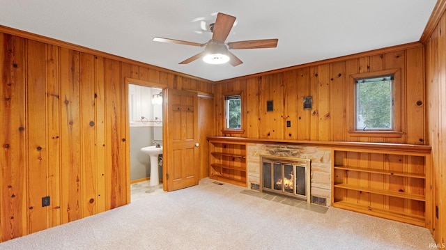 4112 Arlington Ave, Fort Wayne, IN 46807 - unfurnished living room featuring wood walls, a fireplace, carpet, a ceiling fan, and ornamental molding