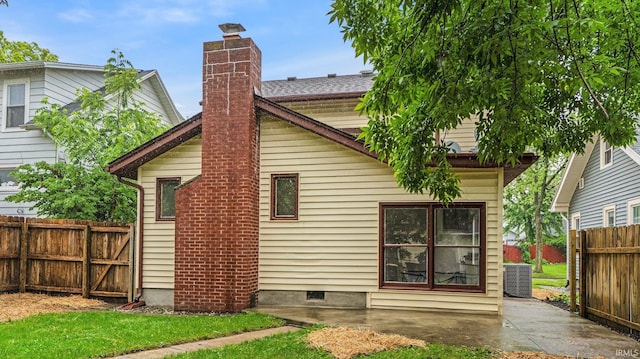 4112 Arlington Ave, Fort Wayne, IN 46807 - rear view of house with a chimney, central AC unit, and a patio area