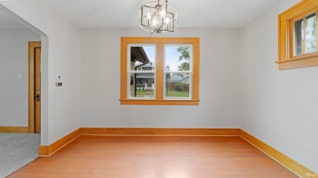 4112 Arlington Ave, Fort Wayne, IN 46807 - unfurnished dining area with light wood-type flooring, healthy amount of natural light, a chandelier, and baseboards