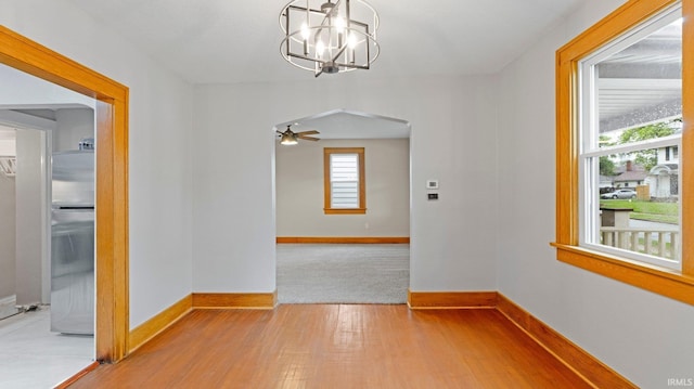 4112 Arlington Ave, Fort Wayne, IN 46807 - empty room with arched walkways, light wood-style flooring, baseboards, and a chandelier
