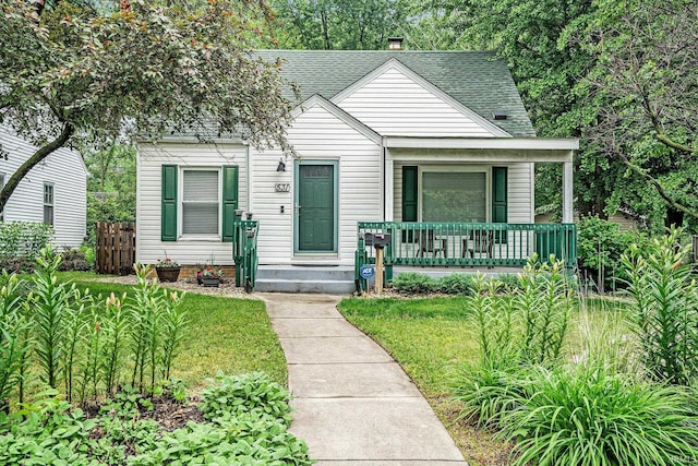 531 W Angela Blvd, South Bend, IN 46617 - bungalow featuring covered porch, roof with shingles, and a chimney