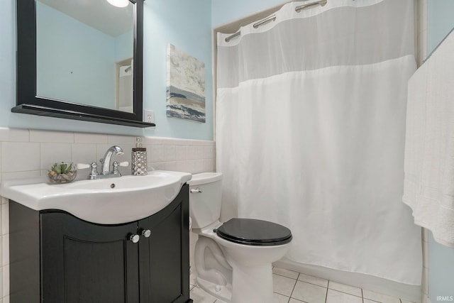 531 W Angela Blvd, South Bend, IN 46617 - bathroom with tile patterned flooring, toilet, vanity, tile walls, and a wainscoted wall