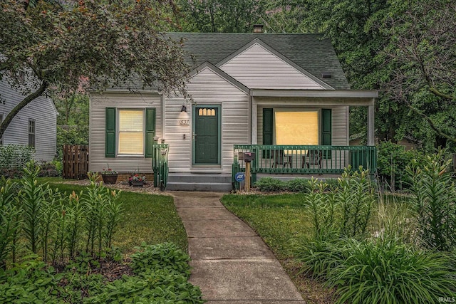 531 W Angela Blvd, South Bend, IN 46617 - bungalow featuring roof with shingles, covered porch, and a chimney