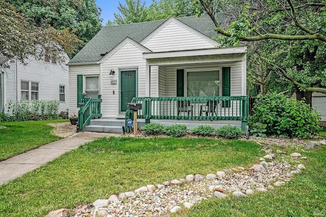 531 W Angela Blvd, South Bend, IN 46617 - view of front of property with covered porch, a shingled roof, and a front lawn