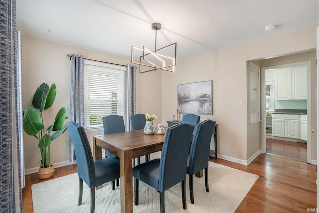 531 W Angela Blvd, South Bend, IN 46617 - dining room with a chandelier, light wood-type flooring, and baseboards