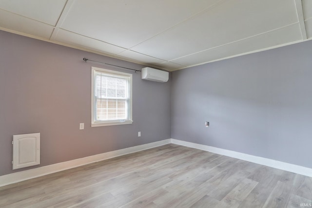 14 S Villa Dr, Evansville, IN 47714 - unfurnished room featuring an AC wall unit, light wood finished floors, and baseboards