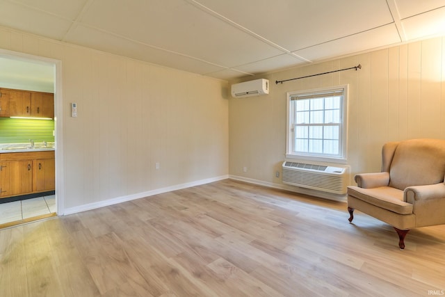 14 S Villa Dr, Evansville, IN 47714 - unfurnished room featuring a wall unit AC, light wood finished floors, and a sink